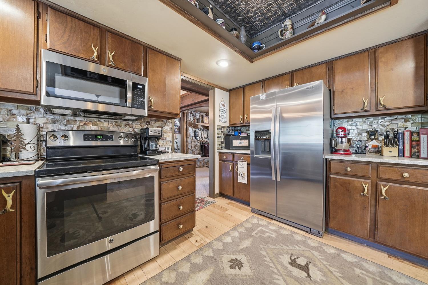 23140 Shake Ridge Road Volcano, CA 95689 - Photo 31 of 81 a kitchen with stainless steel appliances granite countertop a stove a refrigerator and a microwave
