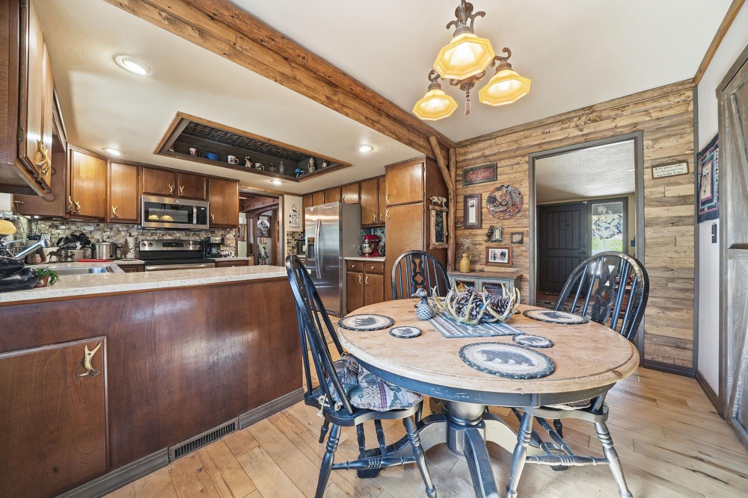 23140 Shake Ridge Road Volcano, CA 95689 - Photo 34 of 81 a view of a dining room with furniture and wooden floor