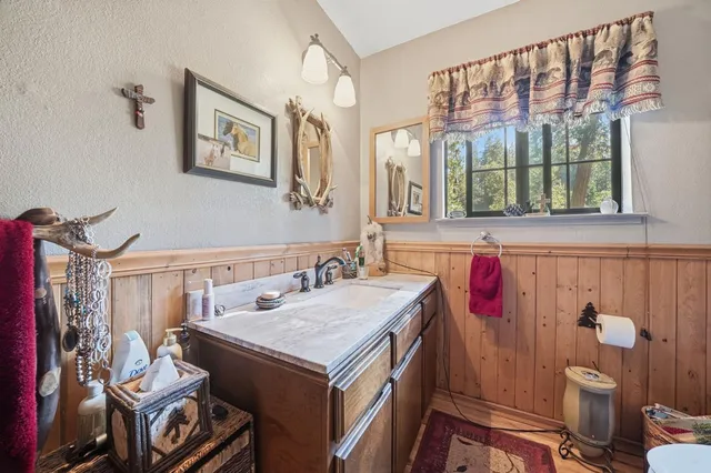 a view of a balcony with chairs and wooden floor