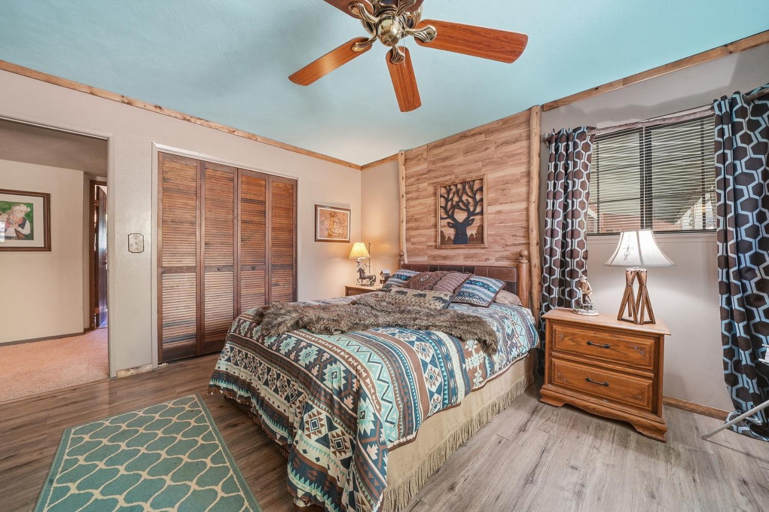 23140 Shake Ridge Road Volcano, CA 95689 - Photo 38 of 81 a bedroom with a bed and a chandelier