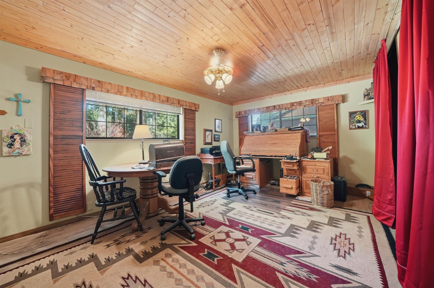23140 Shake Ridge Road Volcano, CA 95689 - Photo 41 of 81 a living room with furniture a rug and a chandelier