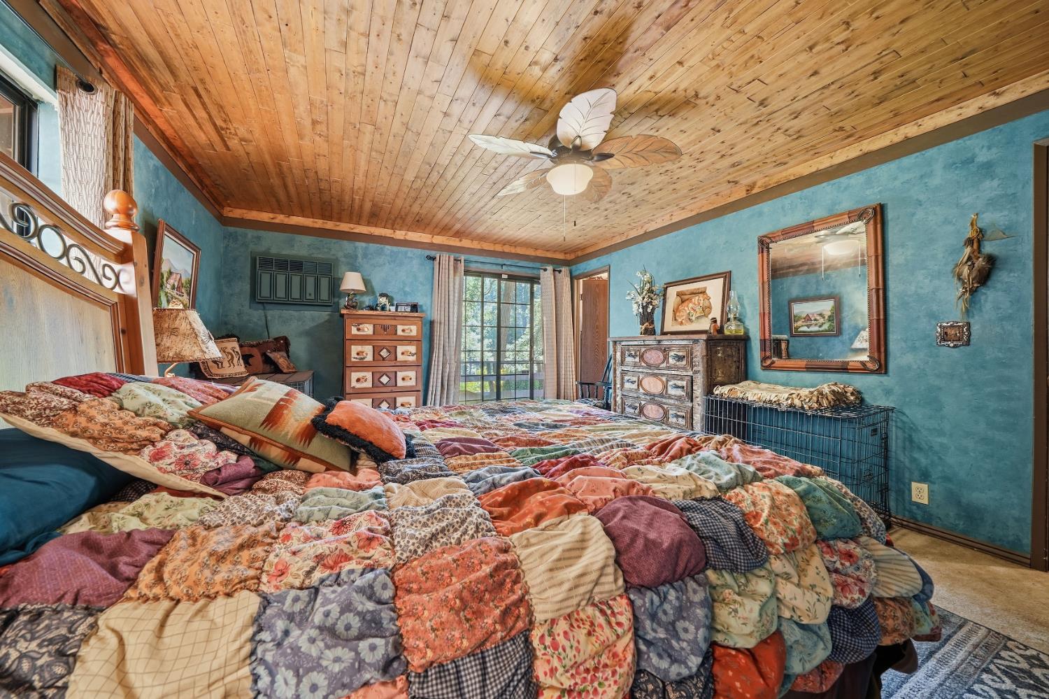 23140 Shake Ridge Road Volcano, CA 95689 - Photo 45 of 81 a bed sitting in a bedroom next to a large window