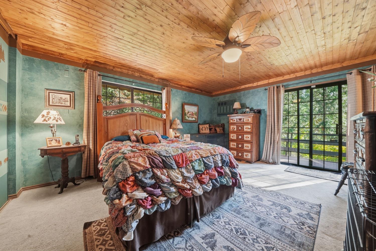 23140 Shake Ridge Road Volcano, CA 95689 - Photo 46 of 81 a bed sitting in a bedroom next to a larger window