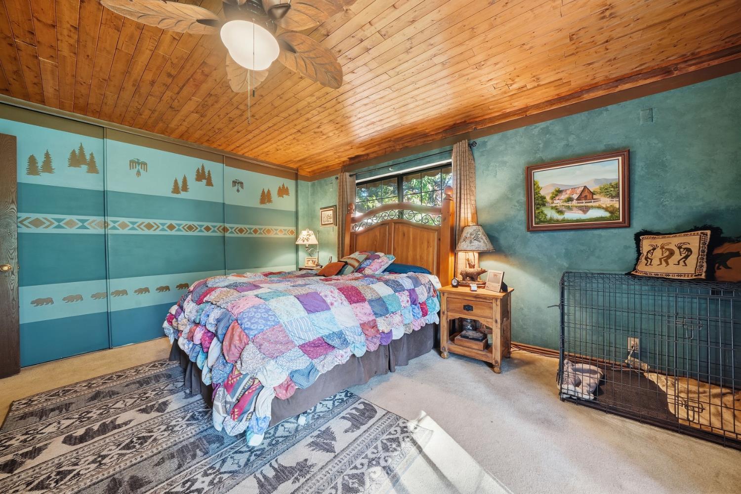 23140 Shake Ridge Road Volcano, CA 95689 - Photo 47 of 81 a bedroom with a bed and a bookshelf