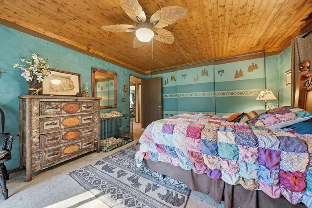 a view of a patio with a table chairs and a floor to ceiling window