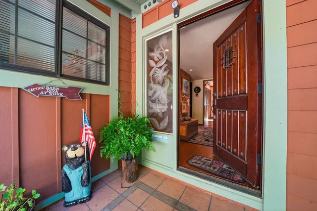 a living room with furniture ceiling fan and a floor to ceiling window