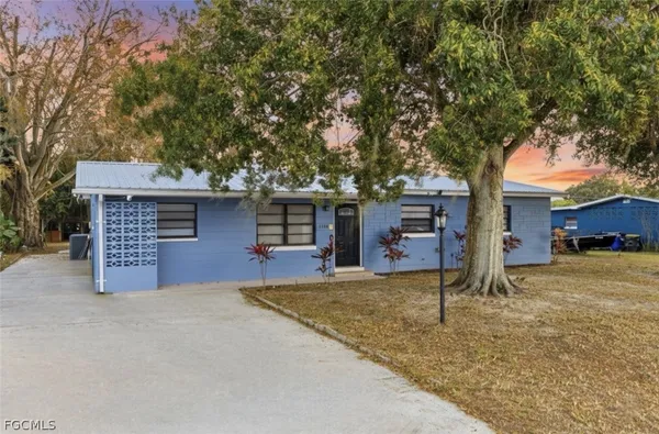 a view of a house with a tree in the background