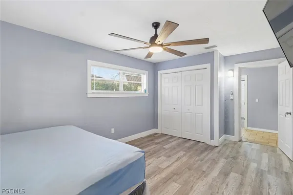 a view of empty room with wooden floor