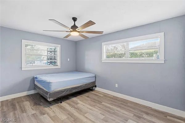 a spacious bedroom with a bed and a window