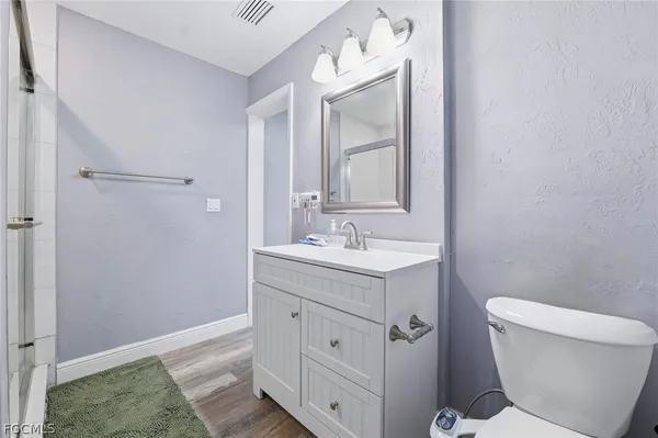 a bathroom with a sink a toilet and a mirror