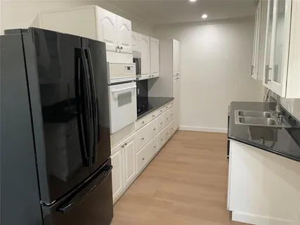 a kitchen with stainless steel appliances a refrigerator and a stove