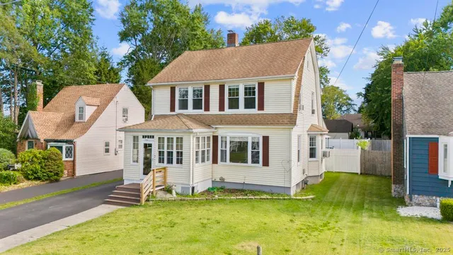 a view of a house with a yard patio and a small yard
