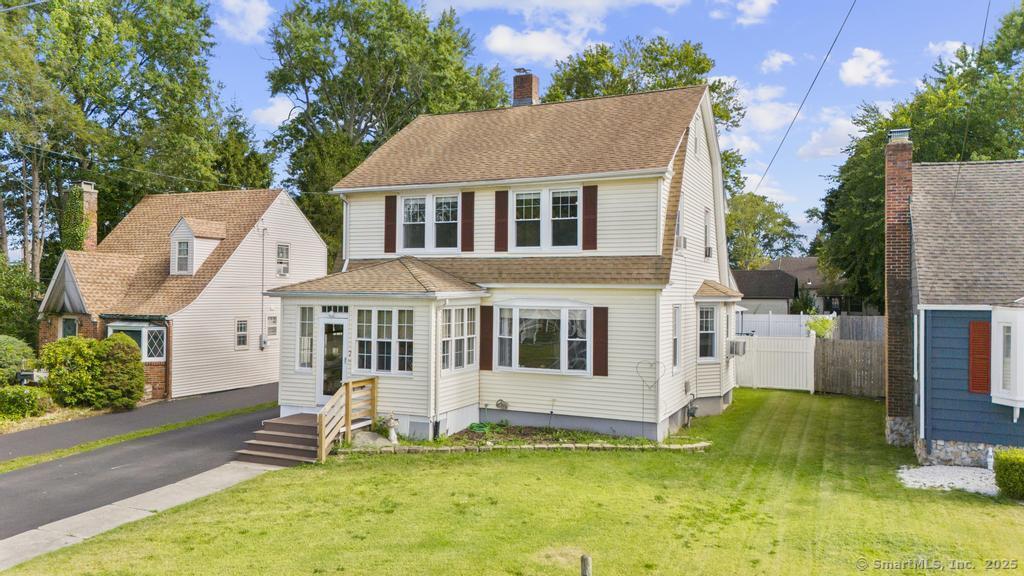a view of a house with a yard patio and a small yard