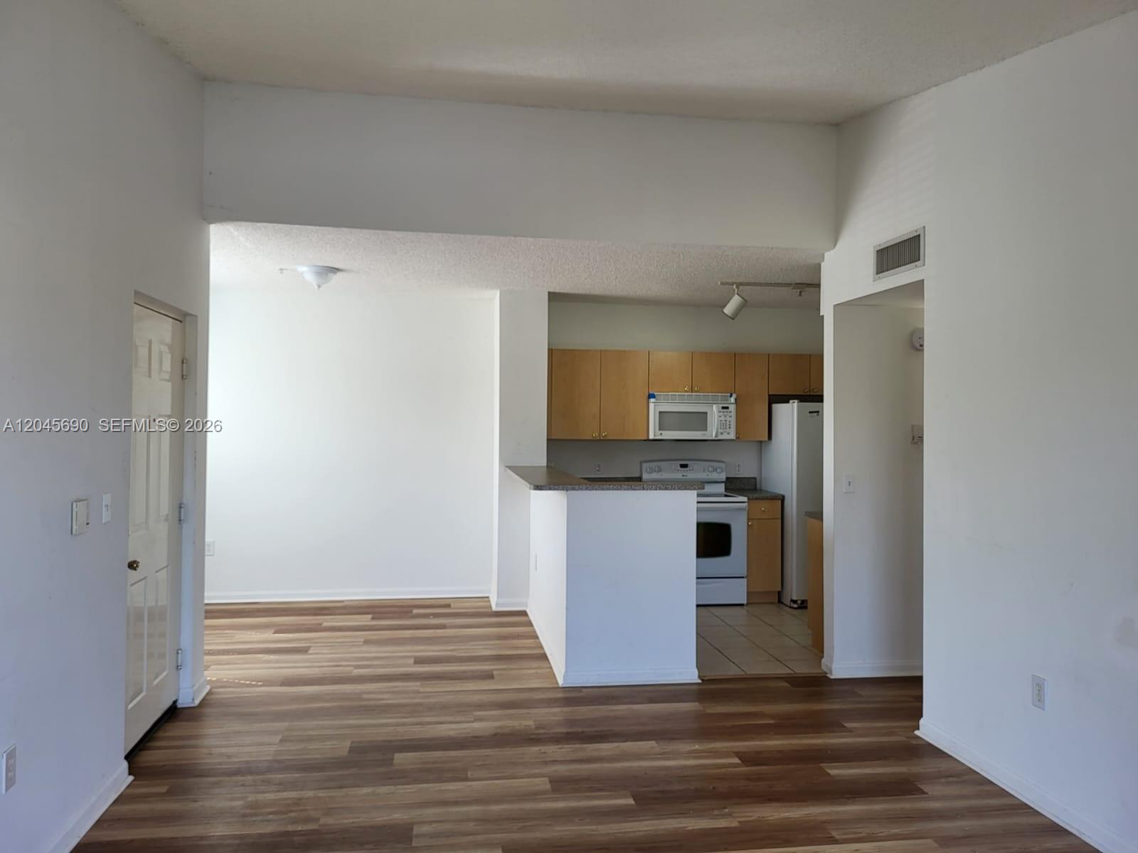 8070 North Nob Hill Road, Unit 208 Tamarac, FL 33321 - Photo 3 of 16 a view of a kitchen from the hallway