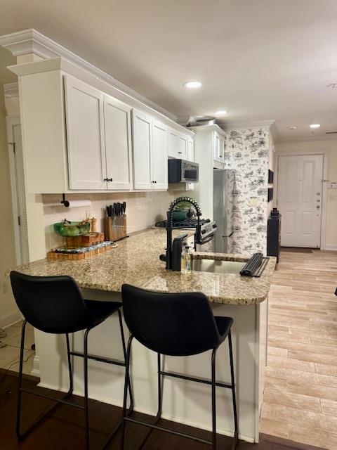 1625 Paterson Plank Road, Unit 1 Secaucus, NJ 07094 - Photo 11 of 19 a kitchen with kitchen island granite countertop a stove a sink and white cabinets with wooden floor