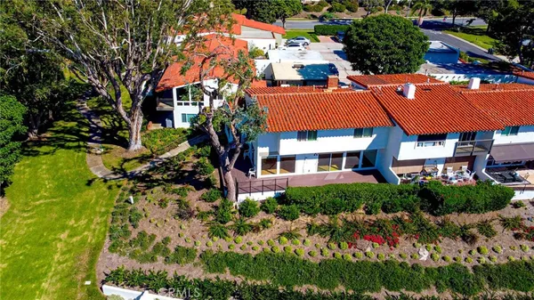 a view of a house with a yard and potted plants