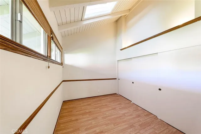 a view of staircase with wooden floor and white walls