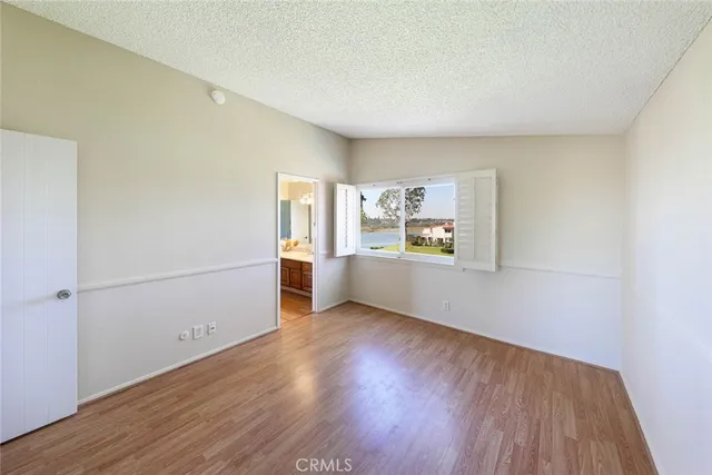 a view of a kitchen with wooden floor and electronic appliances