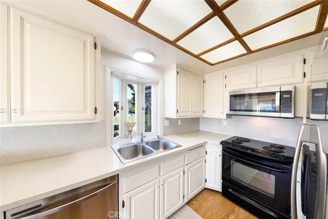 a kitchen with stainless steel appliances sink and cabinets