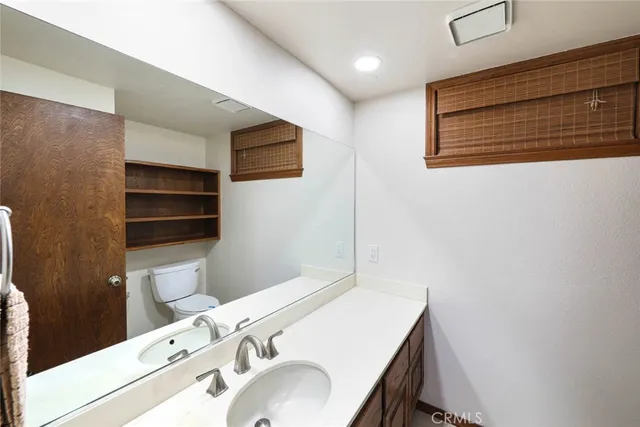 a bathroom with a sink a toilet and a shower