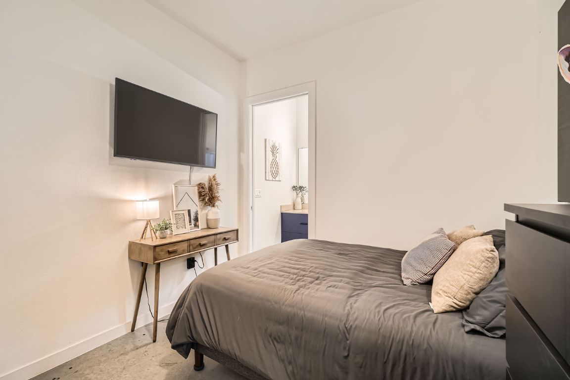 2601 Francisco Street, Unit B Austin, TX 78702 - Photo 10 of 30 a bedroom with a bed and a flat screen tv