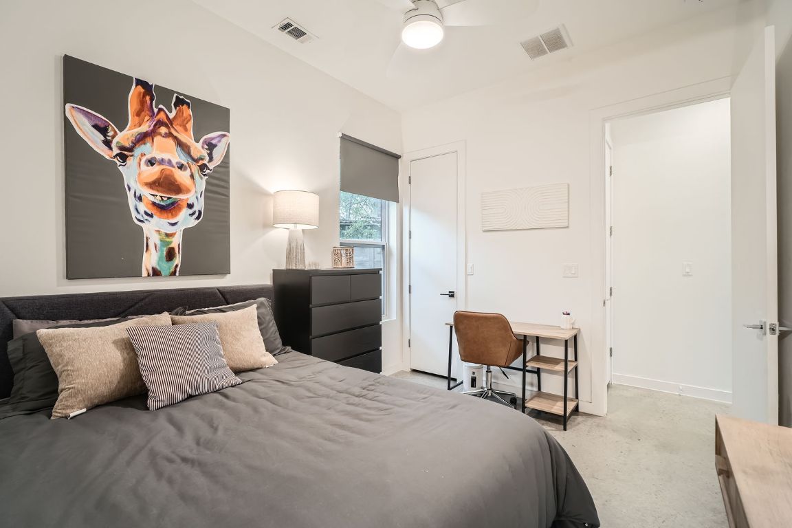 2601 Francisco Street, Unit B Austin, TX 78702 - Photo 11 of 30 a bedroom with a bed and a chair with painting on the wall