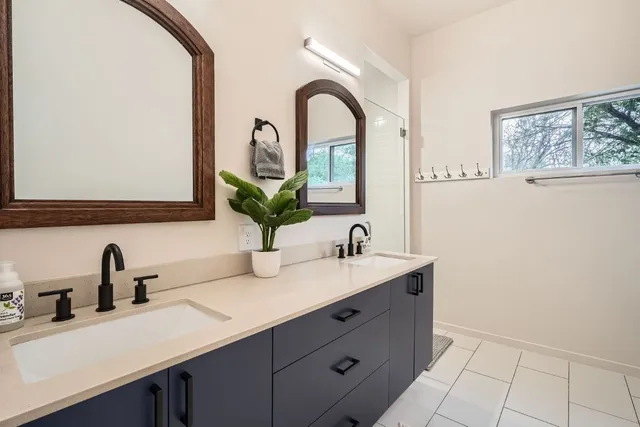 a bathroom with a double vanity sink and a mirror