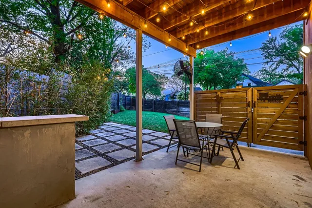 a patio with table and chairs