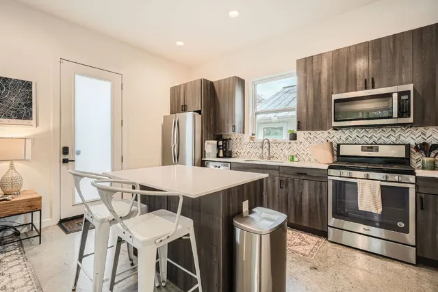 a living room with fireplace furniture and a flat screen tv