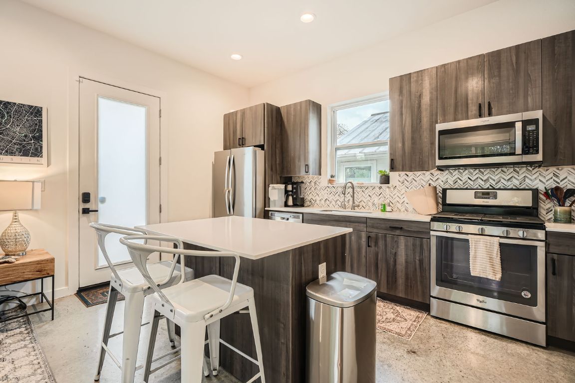 2601 Francisco Street, Unit B Austin, TX 78702 - Photo 6 of 30 a kitchen with stainless steel appliances a stove a sink and a microwave