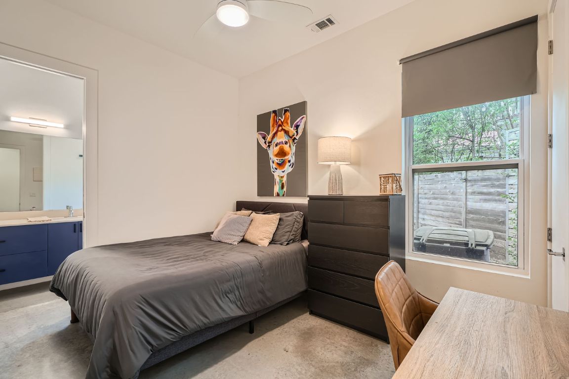 2601 Francisco Street, Unit B Austin, TX 78702 - Photo 9 of 30 a bedroom with a bed and wooden floor