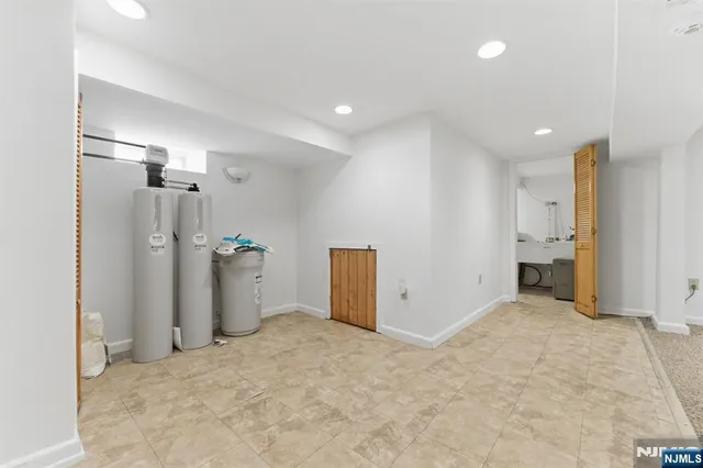 a bathroom with a granite countertop sink a toilet and shower