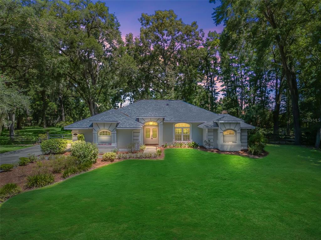 2049 Northwest 111th Loop Ocala, FL 34475 - Photo 1 of 1 a front view of a house with garden