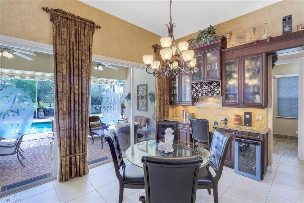 5156 Inagua Way Naples, FL 34119 - Photo 10 of 35 Extra cabinetry, wine cooler and built-in desk in Breakfast Area overlooking the Pool