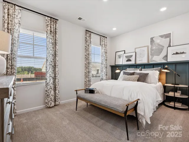 a spacious bedroom with a bed and window