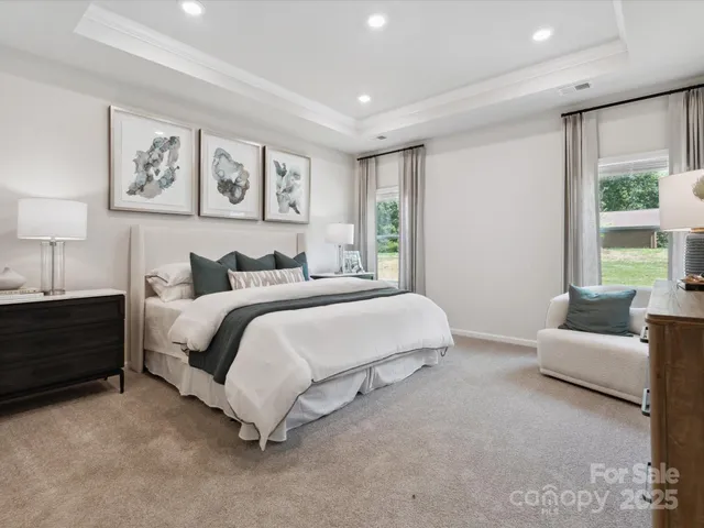 a spacious bedroom with a bed and a couch