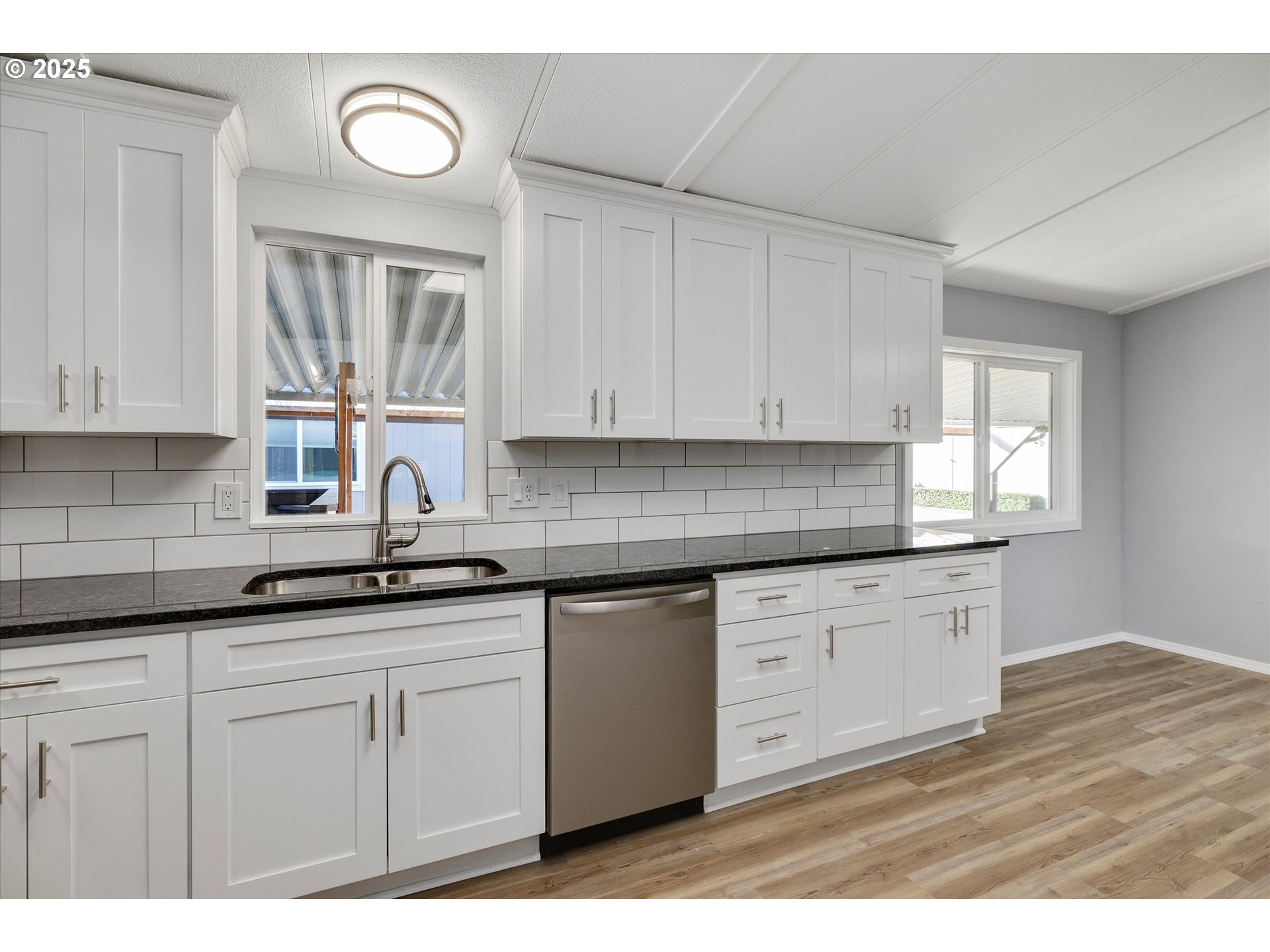 835 Southeast 1st Avenue, Unit 17 Canby, OR 97013 - Photo 12 of 33 a kitchen with granite countertop white cabinets white appliances and a sink