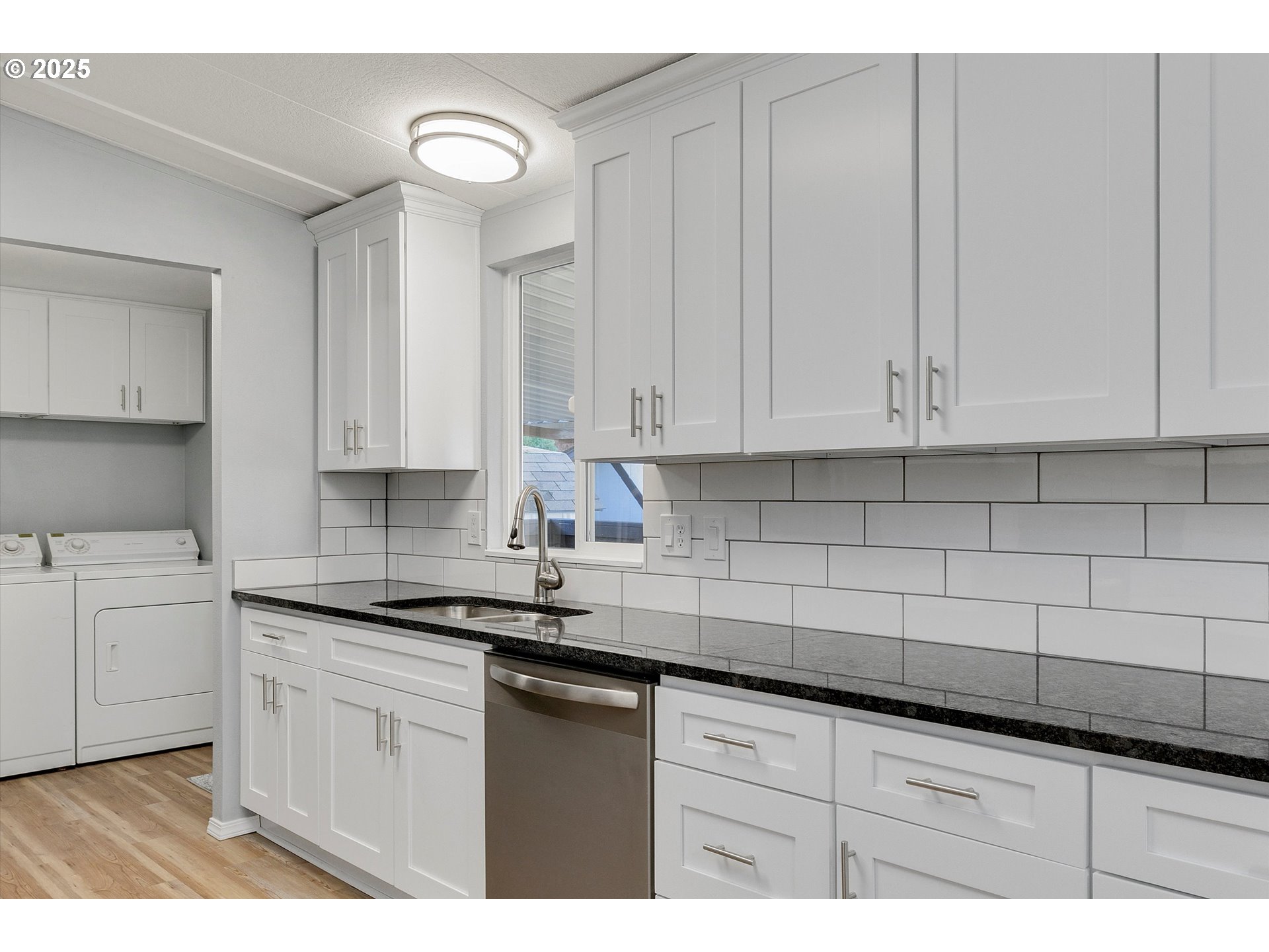 835 Southeast 1st Avenue, Unit 17 Canby, OR 97013 - Photo 13 of 33 a kitchen with granite countertop white cabinets and stainless steel appliances