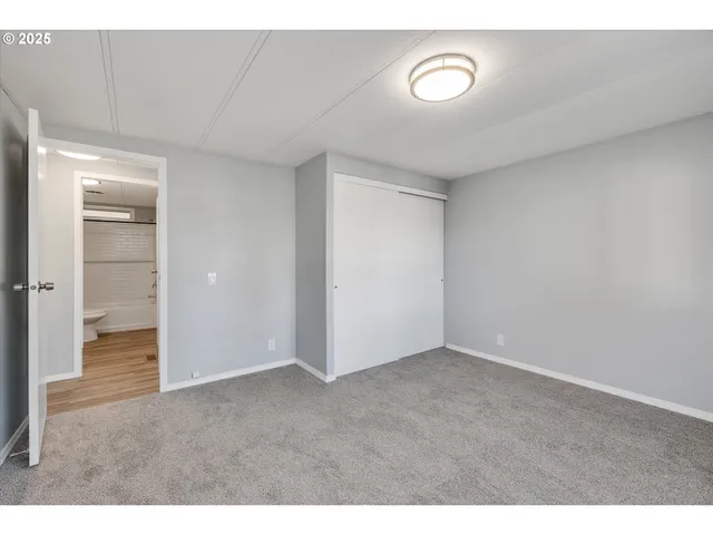a view of an empty room and bathroom