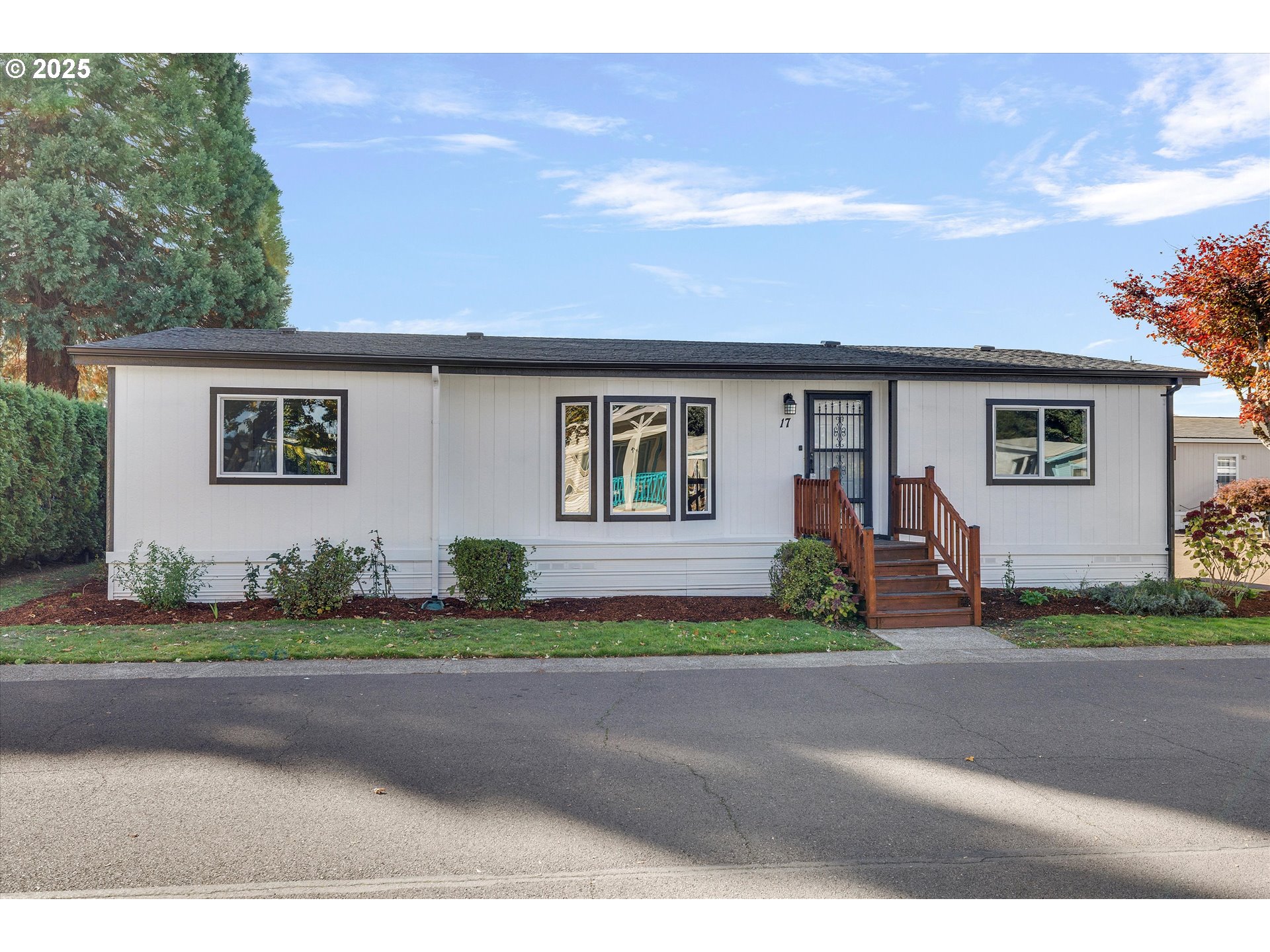 835 Southeast 1st Avenue, Unit 17 Canby, OR 97013 - Photo 2 of 33 a front view of a house with a yard and garage