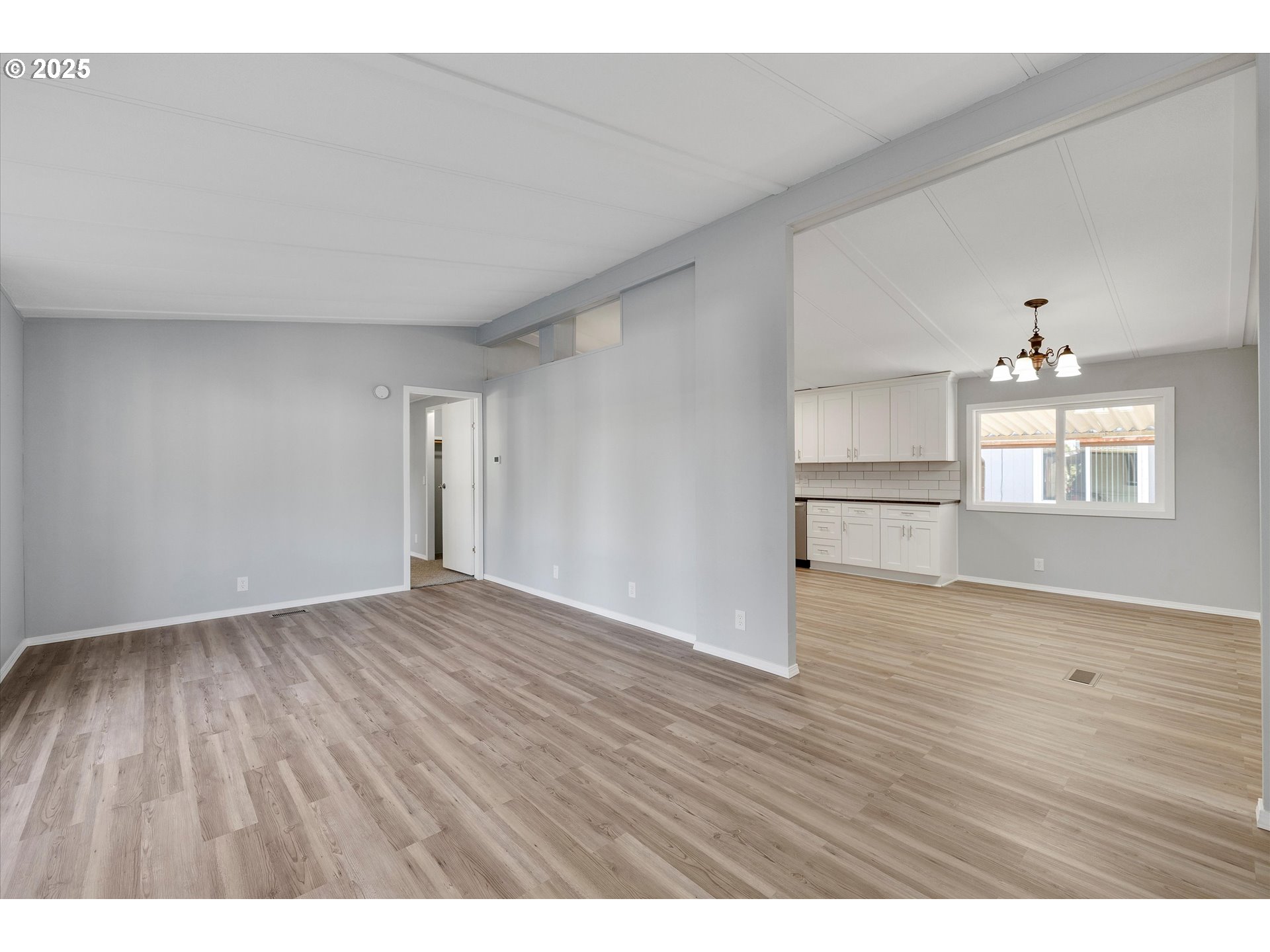 835 Southeast 1st Avenue, Unit 17 Canby, OR 97013 - Photo 7 of 33 a view of wooden floor and windows in a room