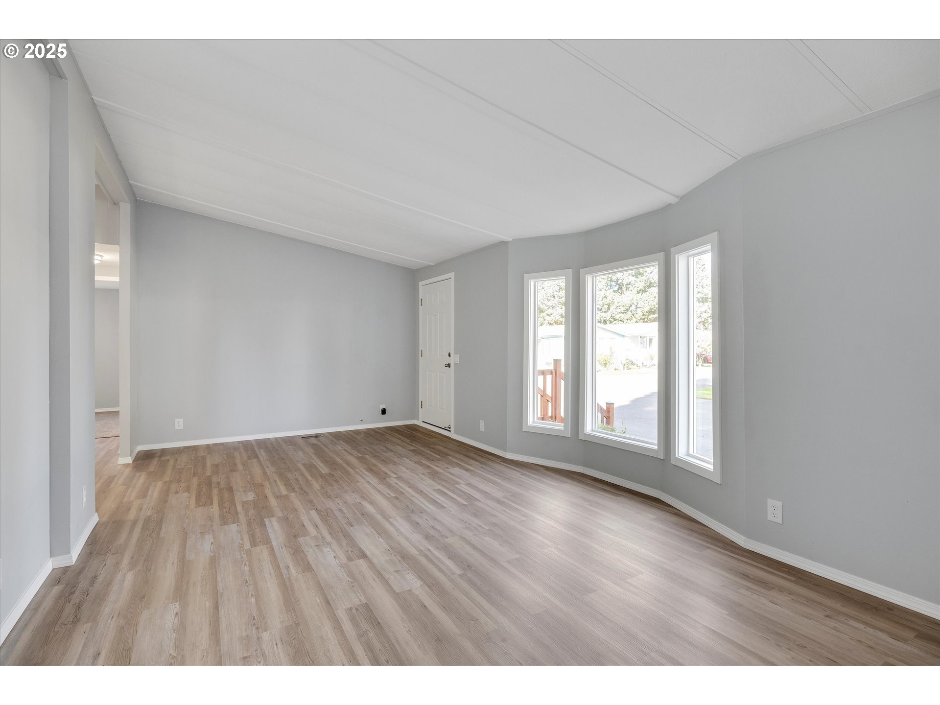 835 Southeast 1st Avenue, Unit 17 Canby, OR 97013 - Photo 8 of 33 wooden floor in an empty room with a window
