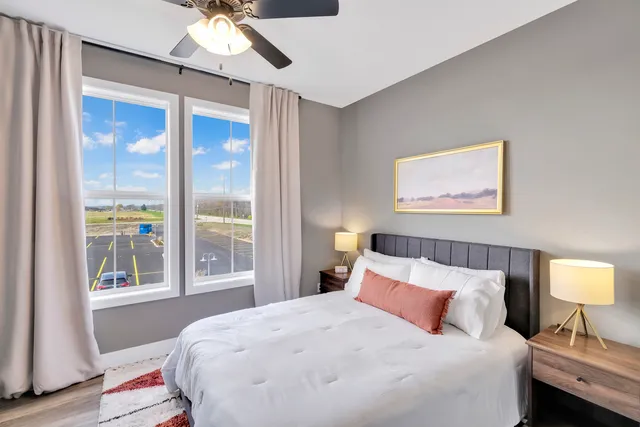 a bedroom with a large bed and a window