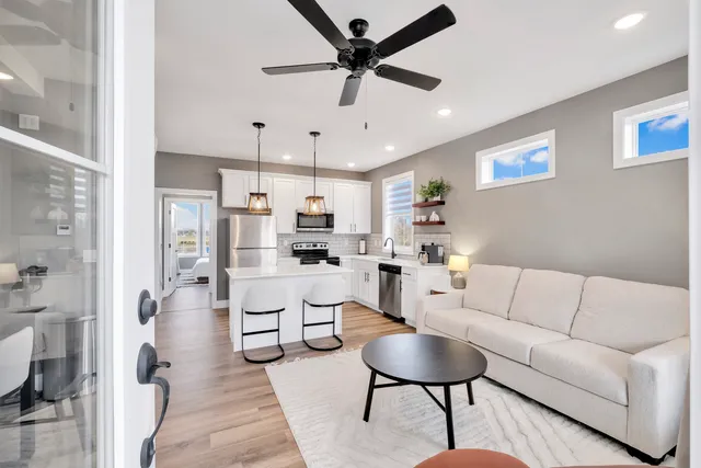 a living room with furniture and kitchen view