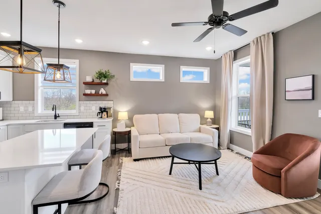 a living room with furniture and a wooden floor