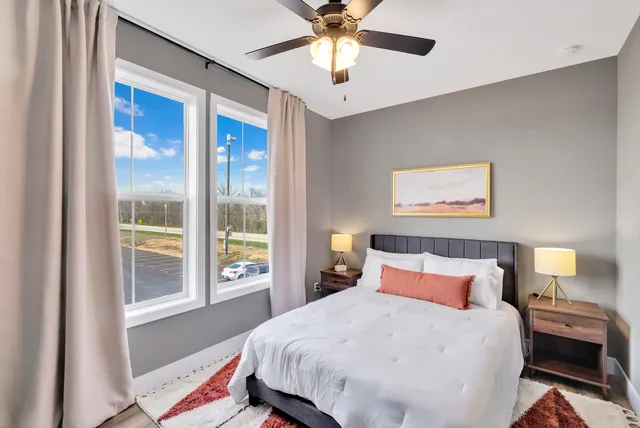 a bedroom with a large bed and a window