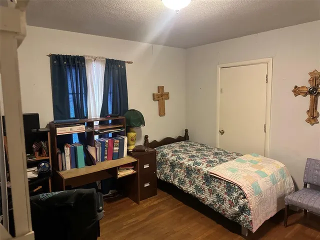 a bedroom with a bed a book shelf and books
