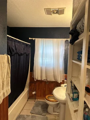 a bathroom with a toilet sink and tub