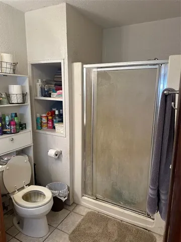 a bathroom with a toilet and a shower