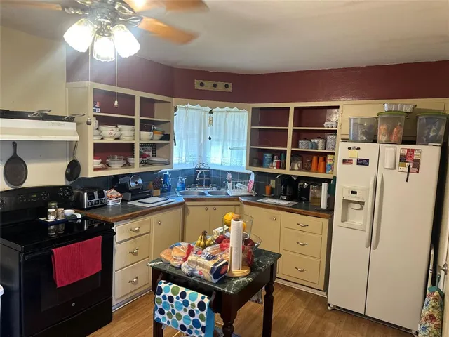 a kitchen with stainless steel appliances a stove a refrigerator and cabinets